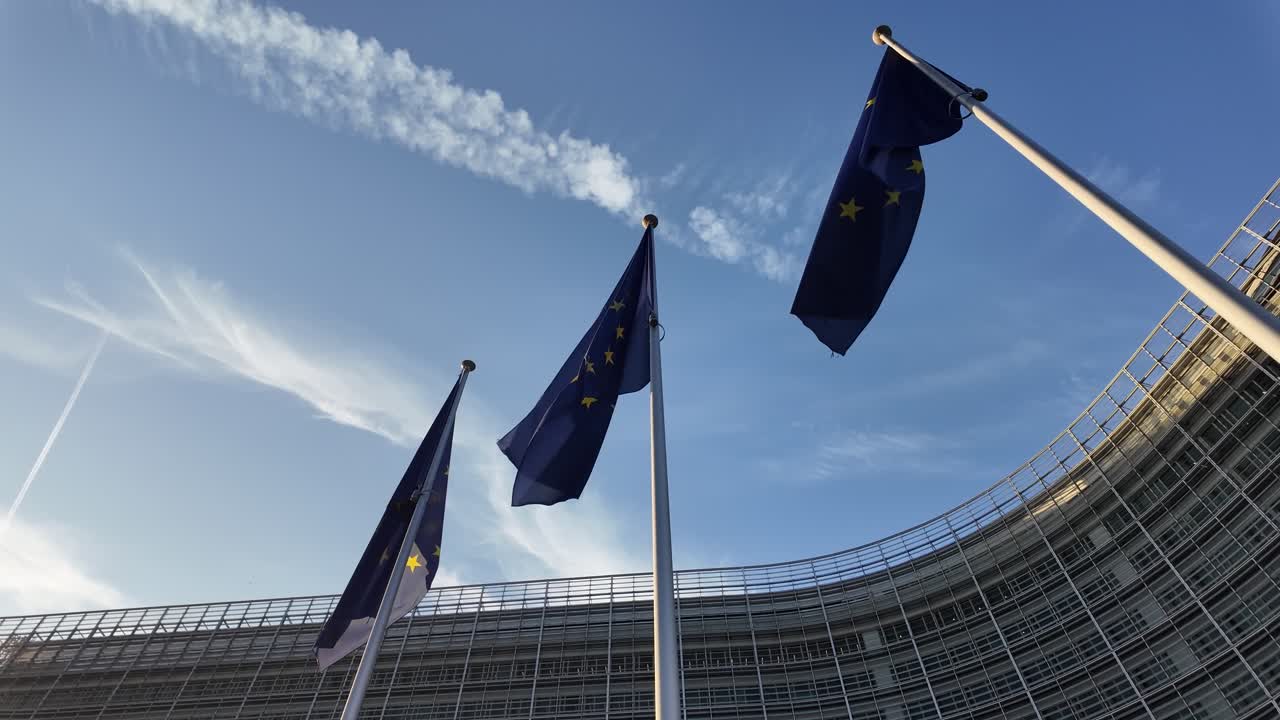 European Union flags waving at Berlaymont building in Brussels