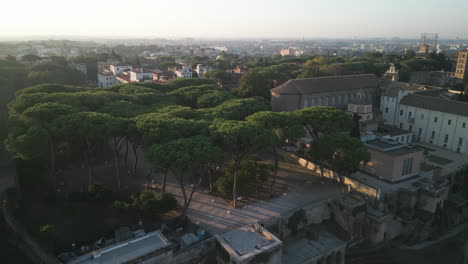 Aerial-establishing-shot-at-sunset-above-tree-garden-in-Orange-Garden-Italy