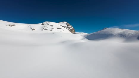 Aerial-image-near-the-snow-in-the-ski-slope-area-in-Crans-Montana,-Swiss-Alps,-Switzerland