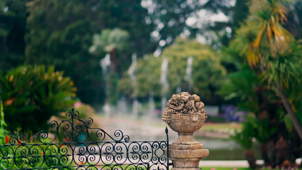 Close up of a decorative stone pillar in the courtyard of Villa Ephrussi de Rothschild with a blurred view on the background