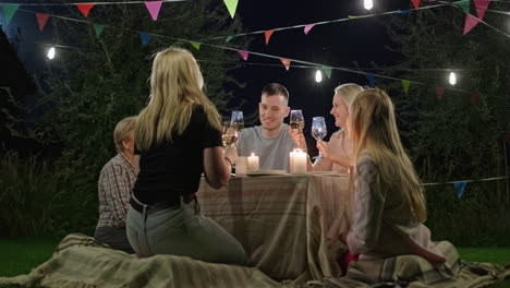 friends gathering in the garden at night