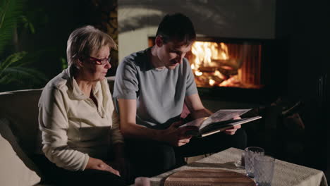 grandchild and grandparent sharing memories by the fireplace