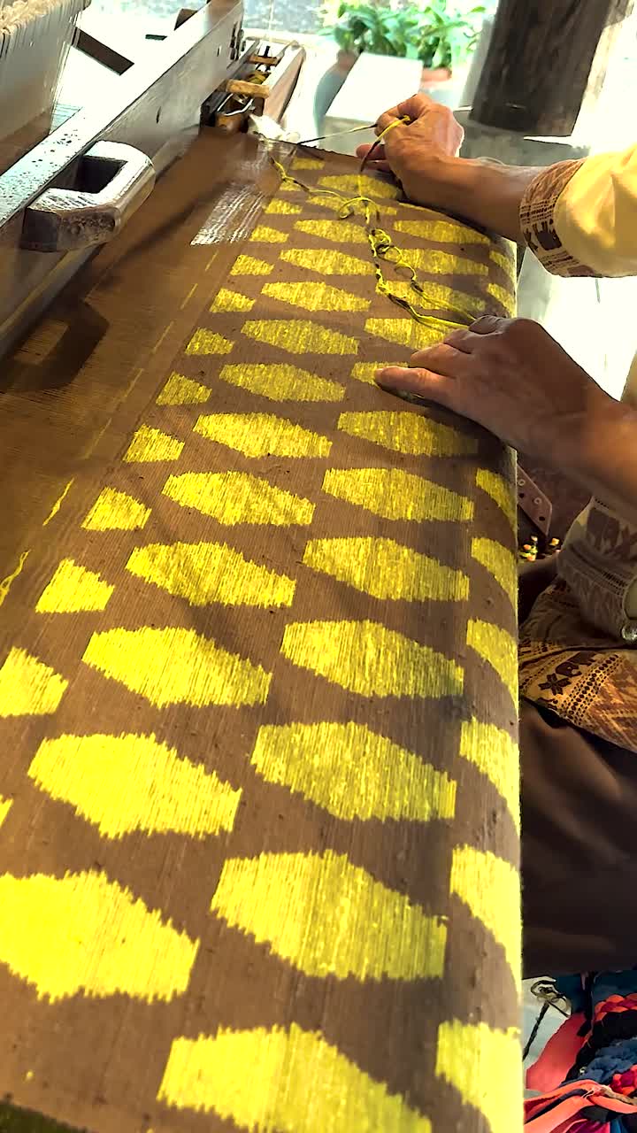 Artisan weaving intricate silk patterns by hand