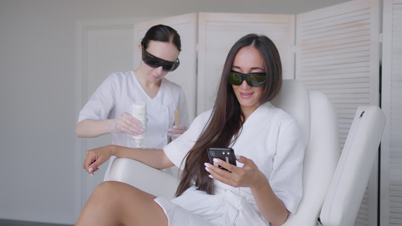 Laser epilation. Woman getting laser hair removal procedure on her legs. Beauty laser treatment salon clinic cosmetology beautician professional profession body care concept
