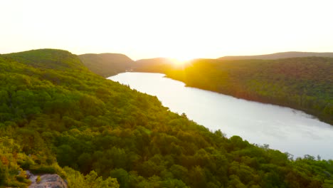 aerial flight above lake of the clouds overlook in michigan's porcupine mountains during sunrise