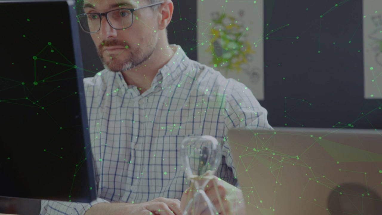 Designer reaching, checking time while camera moving closer, green particles accenting hourglass
