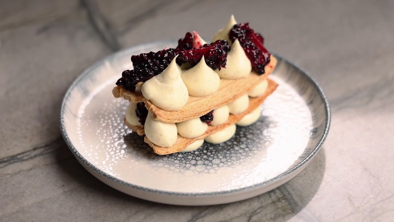 Millefoglie gourmet con more fresche su un piatto