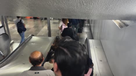 first-person shot of a man's head, taken from an escalator