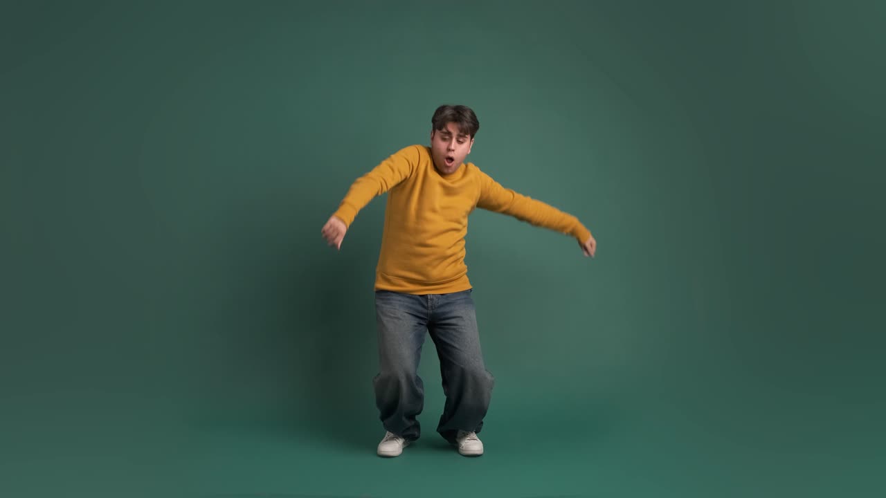 Cheerful ethnic young man doing dance moves