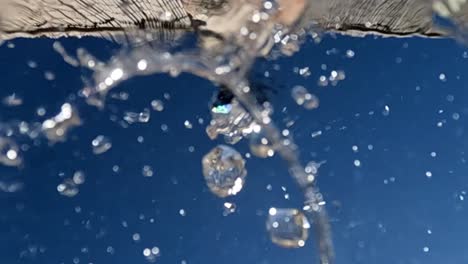 unusual perspective of drinking fountain with water flowing downward on camera