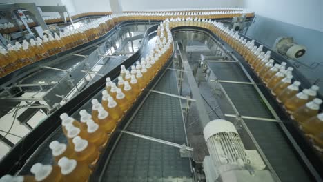 conveyor belt with bottles for juice or water at a modern beverage plant. modern production of sweet soda water