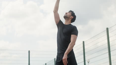 lower view of brunet man hitting a volleyball