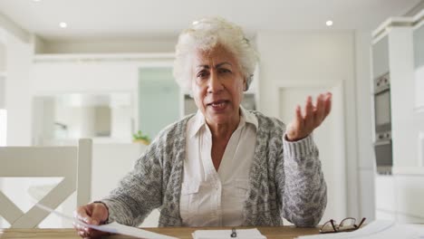 portrait of african american senior woman holding a document talking looking at the camera