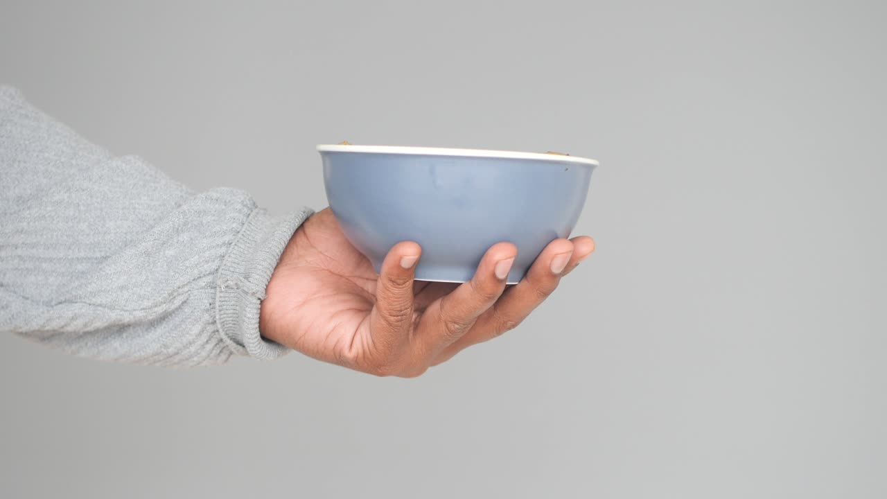 Person holding a bowl of food
