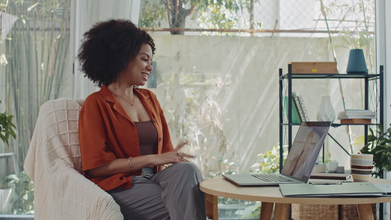 Female Psychologist Greeting Client during Online Call on Laptop at Home