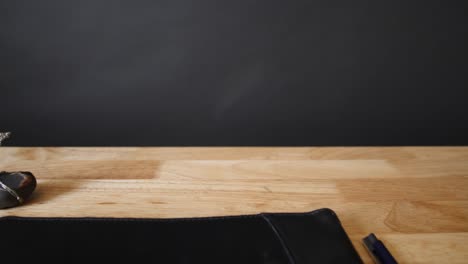 minimalist desk with a wire tree and black notebook pulling