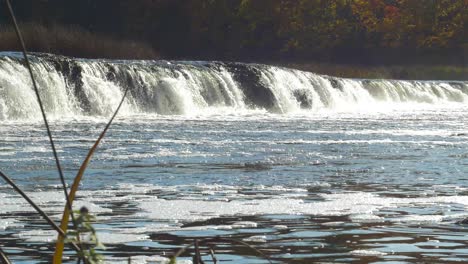 venta river rapid wide shot, the widest waterfall in europe in sunny autumn day, located in kuldiga city, latvia