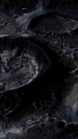 a close-up of the moon's surface, with craters and dark, rocky landscape