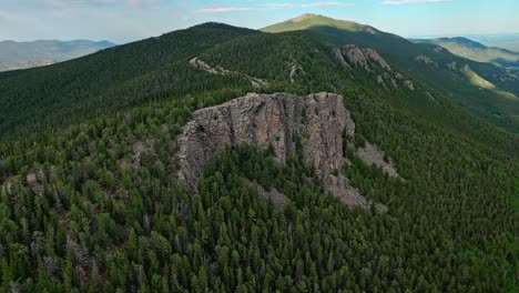 Rock-escarpment-rises-above-continental-divide-and-evergreen-forest-along-Mount-Blue-Sky-scenic-byway