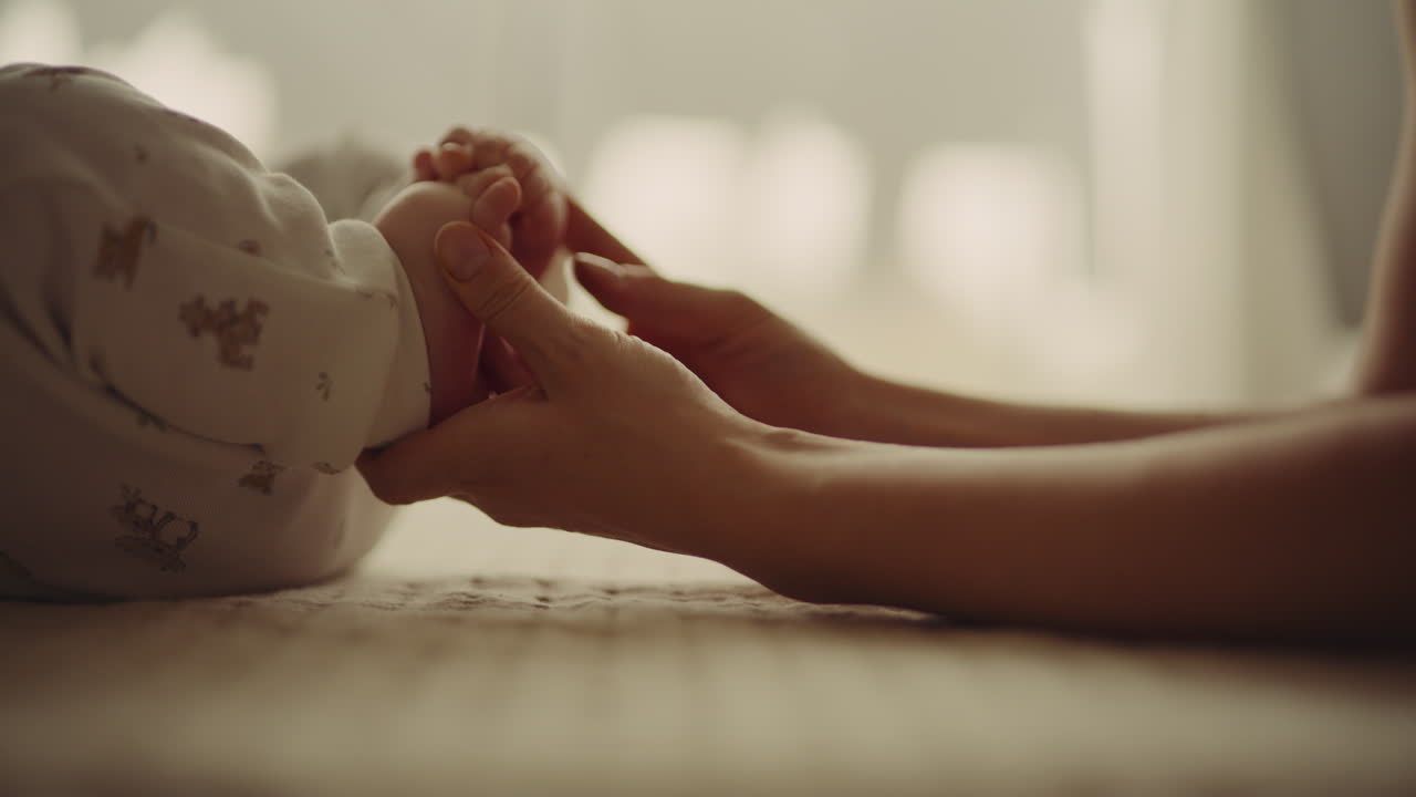 Newborn Baby Feet Touched by Mother