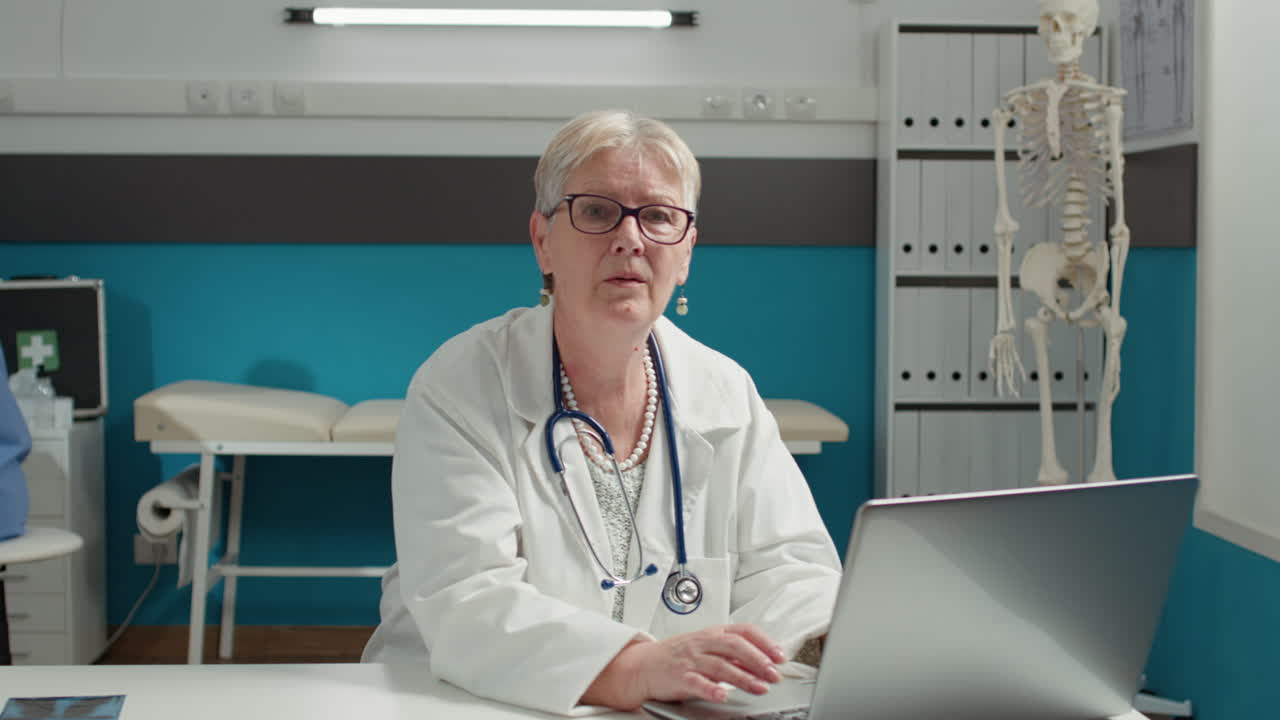 Portrait of female health specialist working with laptop