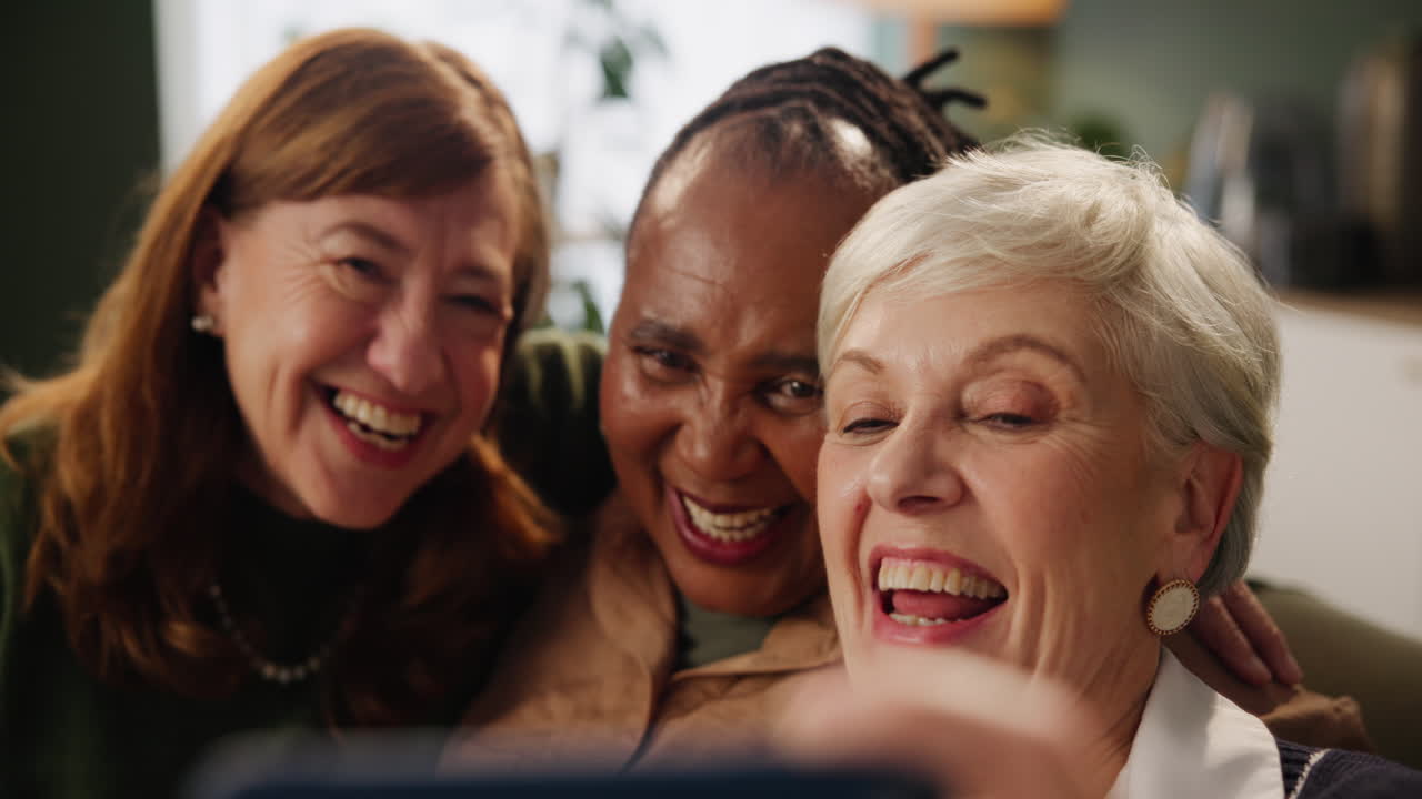 Three happy women taking a selfie