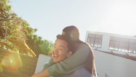 Video-of-happy-diverse-couple-talking-and-embracing-in-garden