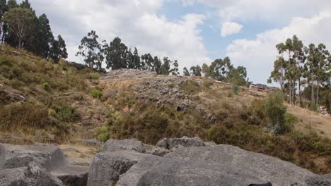 Qenqo-carved-rocks-on-side-of-mountain,-Peru---4k