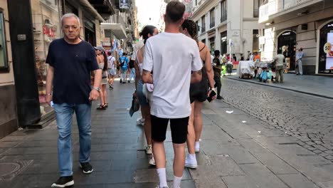 people walking and interacting on a city street