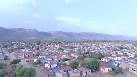 a township in midrand, south africa with houses and surrounding mountains, aerial view