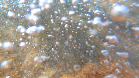 POV-from-within-the-surf-being-buffeted-around-within-the-waves-surrounded-by-sand-and-bubbles-and-wave-froth