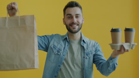 man delivering coffee and takeout order