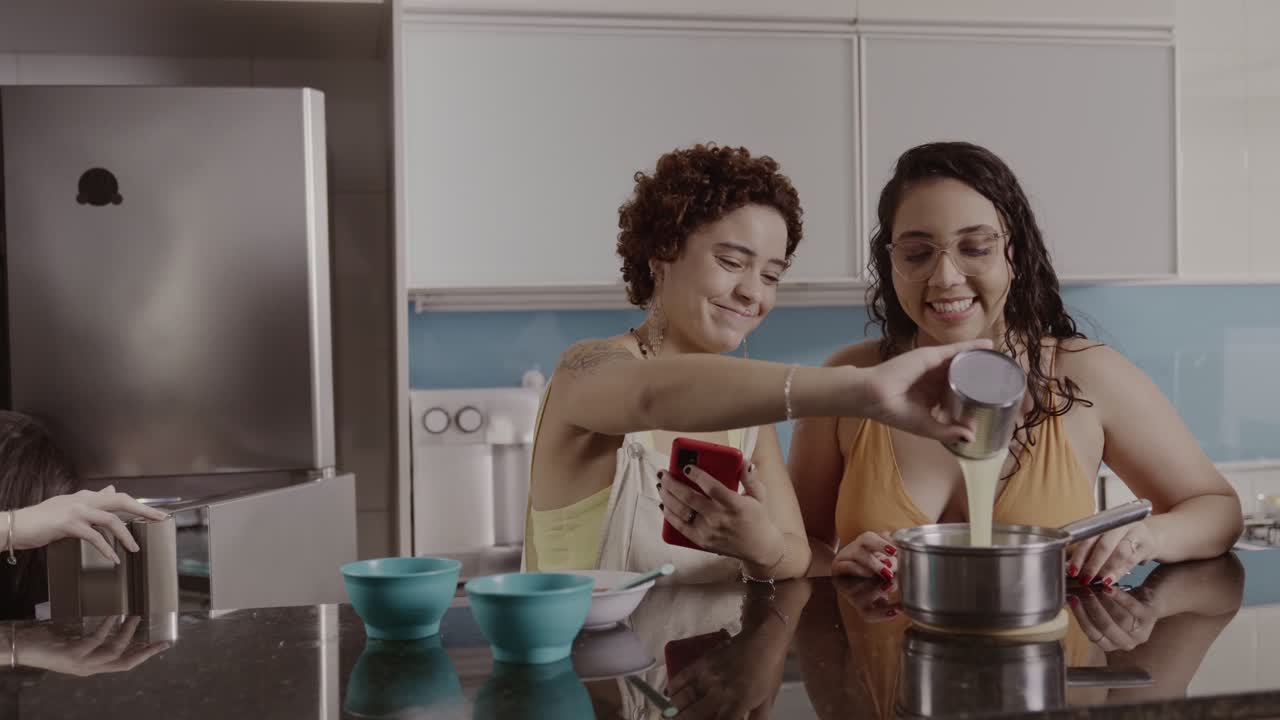 Friends cooking and preparing food together in a modern kitchen