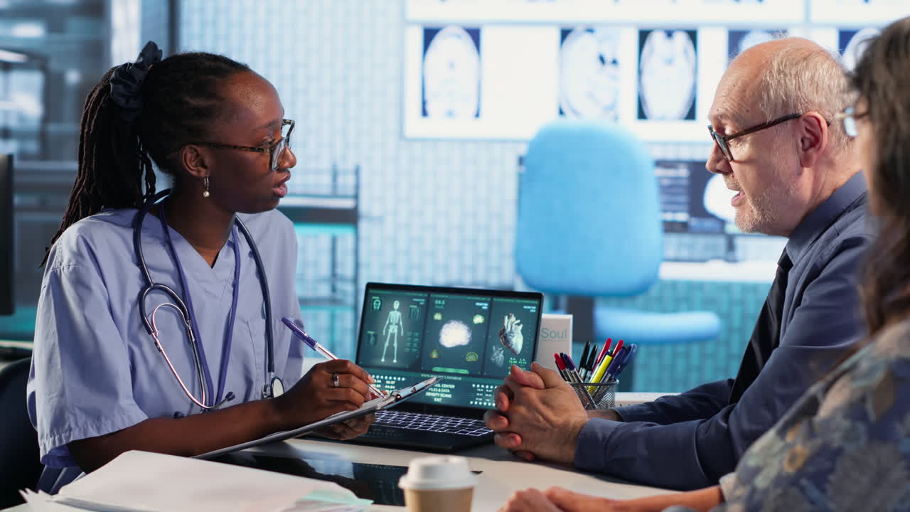 Vertical Video Female nurse and patients reviewing diagnostic results in a medical office
