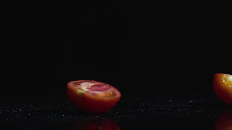 sliced tomatoes on black background