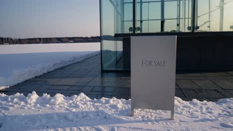 modern glass building for sale in winter landscape
