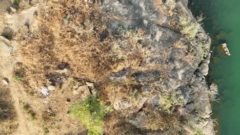 breathtaking spinning aerial view of a rocky waterfront with canoes