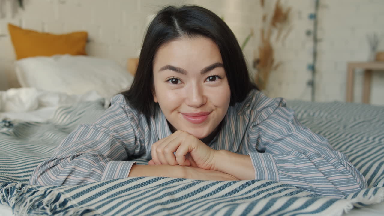 Happy woman lying in bed