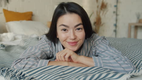 happy woman lying in bed