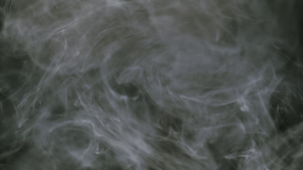 Dense White Smoke Swirling Against a Dark Background