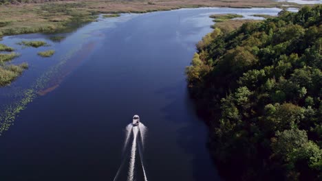 Speedboat-cruising-at-Lake-skadar-Montenegro-during-day-time,-aerial