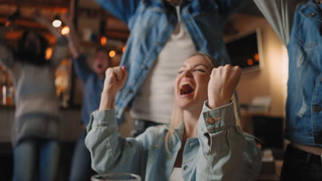 portrait of a female fan watching football in a bar with friends.  football hockey basketball sports games.