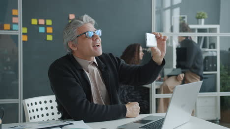 businessman taking a selfie in the office