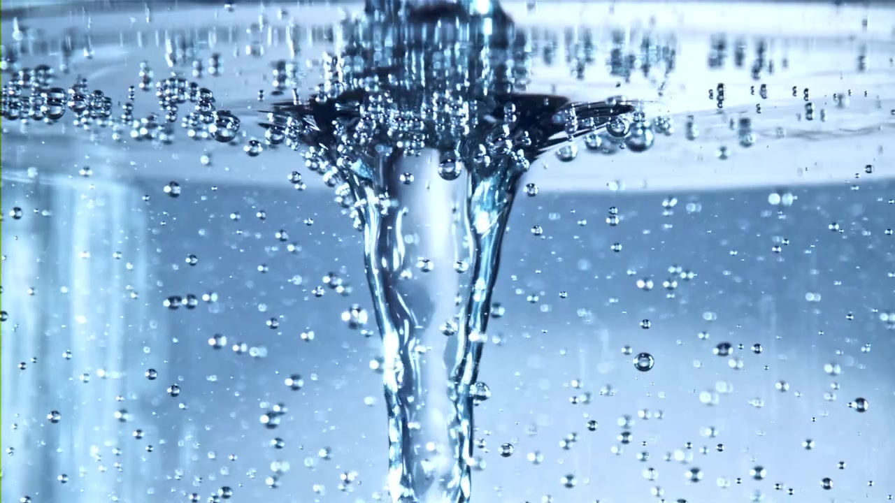 Close-up of Water Swirling into a Vortex with Bubbles