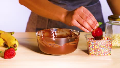 strawberry dipped in chocolate and colorful sprinkles