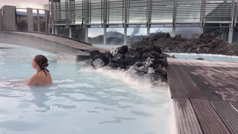 young attractive girl relaxing in the thermal waters of blue lagoon spa