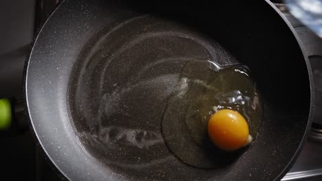 cooking fresh eggs in a pan in the morning