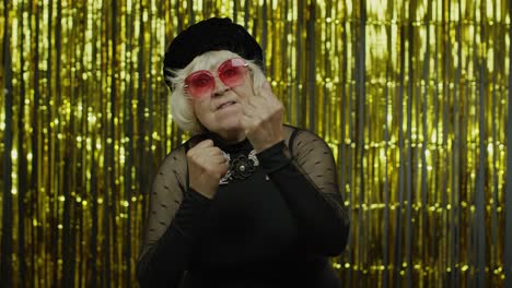 senior woman dancing and posing in a glamorous studio