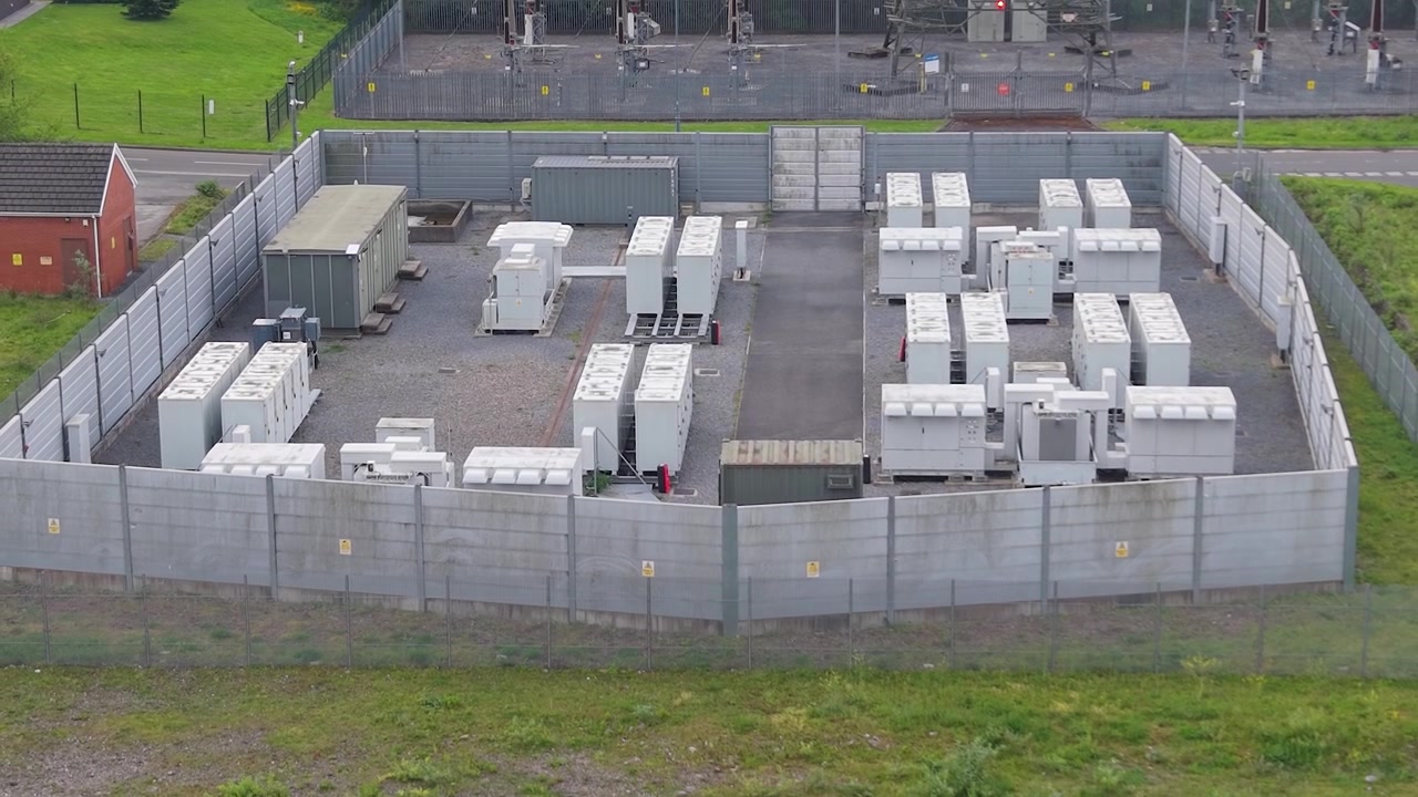 Installazione di un sistema di accumulo di energia a batteria BESS a ioni di litio. Ripresa aerea in allontanamento. Il futuro dell'energia pulita, delle iniziative a zero emissioni di carbonio e della tecnologia sostenibile. Regno Unito.