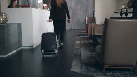 business woman with travel suitcase arriving in hotel at vacation